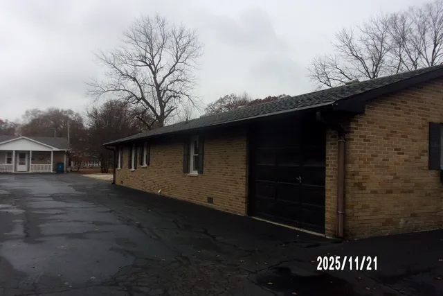 a backyard of a house with large trees