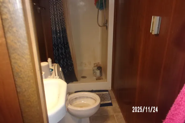 a bathroom with a light fixture and a fan