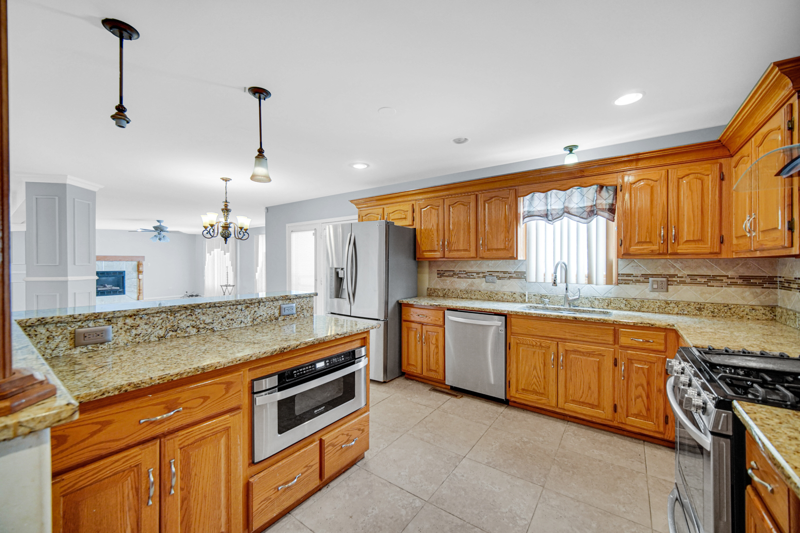 15516 Frontage Road Markham, IL 60428 - Photo 14 of 36 a kitchen with stainless steel appliances granite countertop a stove a sink and a refrigerator