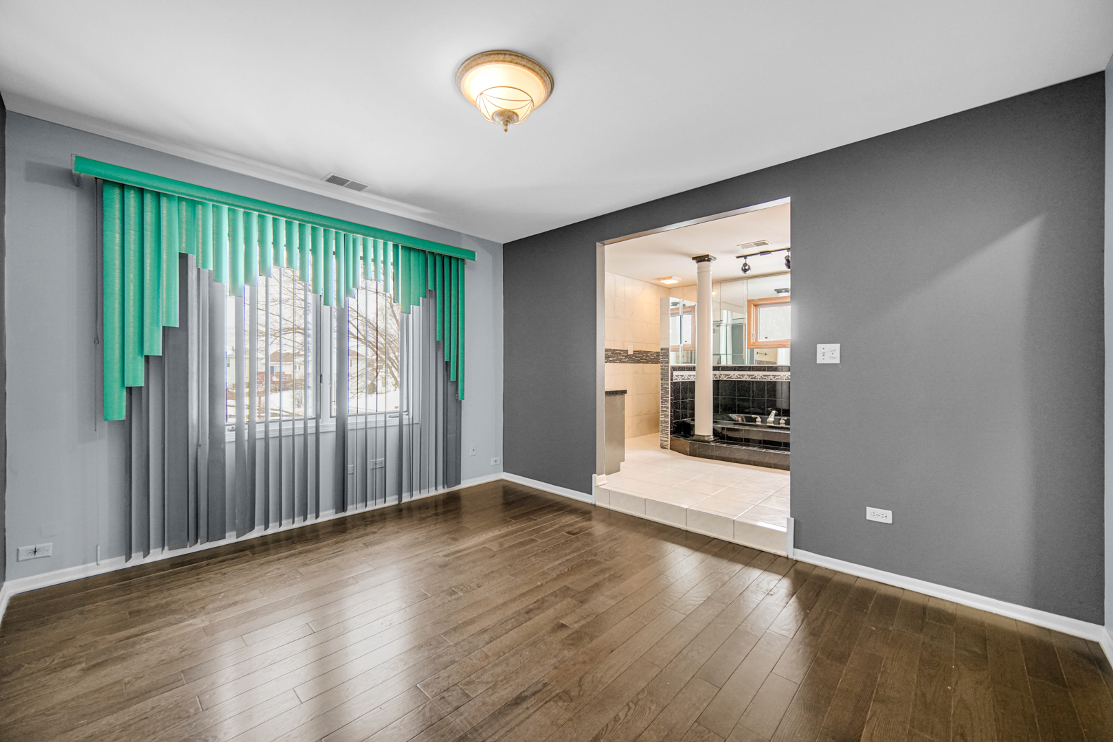 15516 Frontage Road Markham, IL 60428 - Photo 20 of 36 an empty room with wooden floor and windows