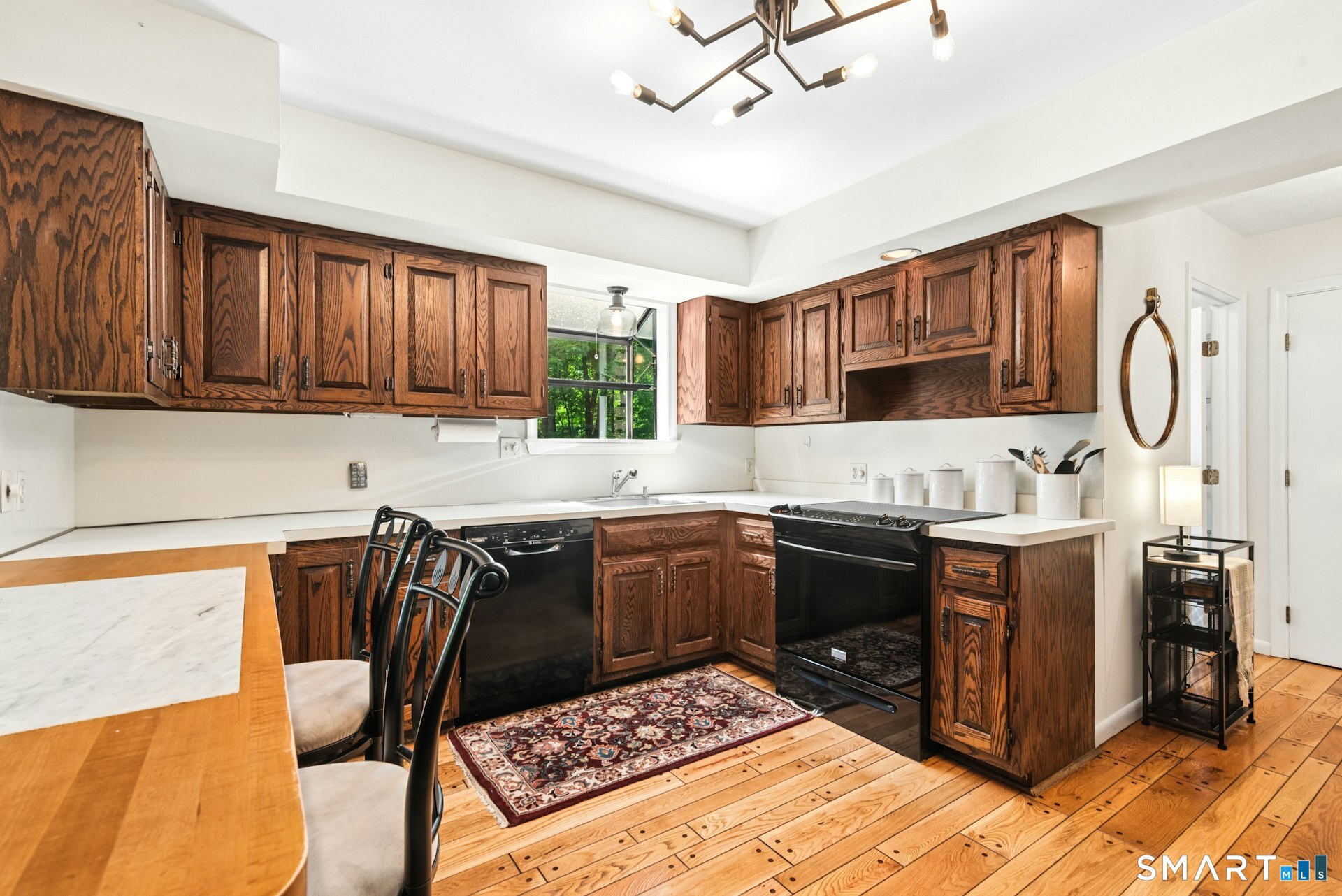 127 Huntingtown Road Newtown, CT 06470 - Photo 13 of 38 a kitchen with stainless steel appliances granite countertop a stove top oven a sink dishwasher and cabinets with wooden floor