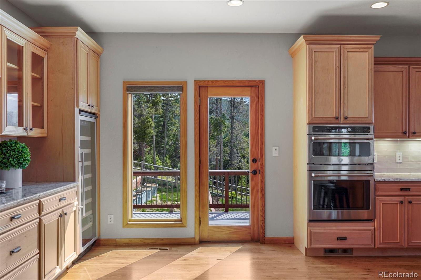 29549 Thunderbolt Circle Conifer, CO 80433 - Photo 12 of 50 a kitchen with stainless steel appliances a stove and more cabinets