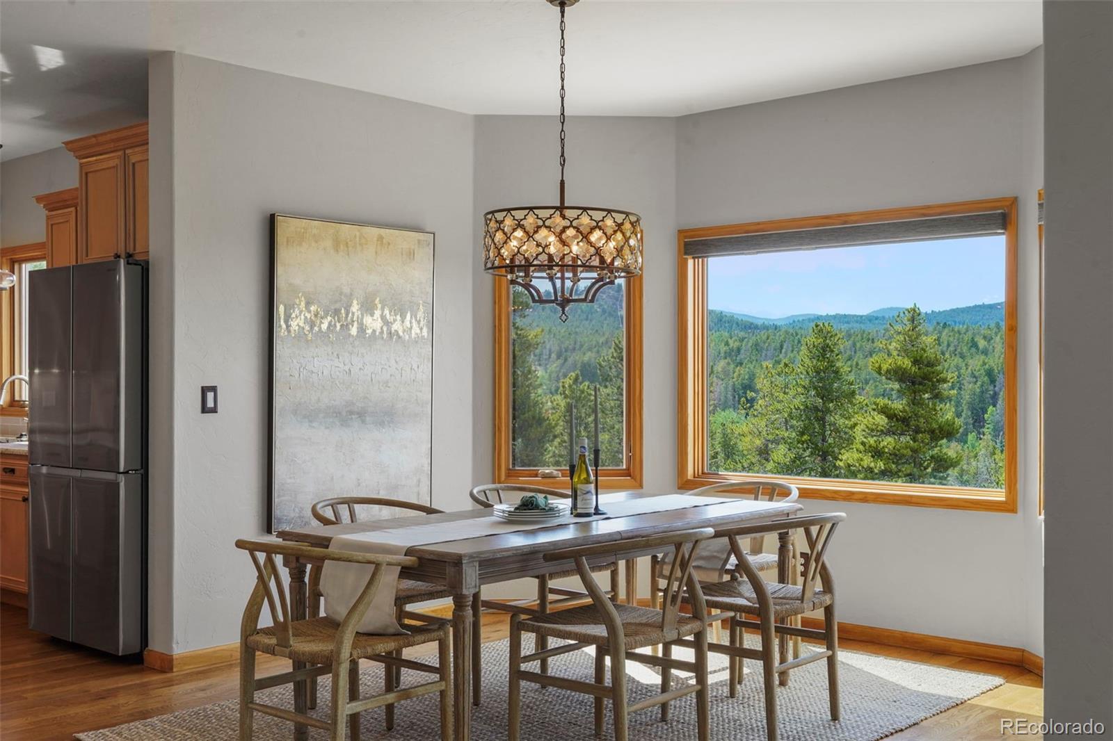 29549 Thunderbolt Circle Conifer, CO 80433 - Photo 14 of 50 a view of a dining room with furniture window and wooden floor