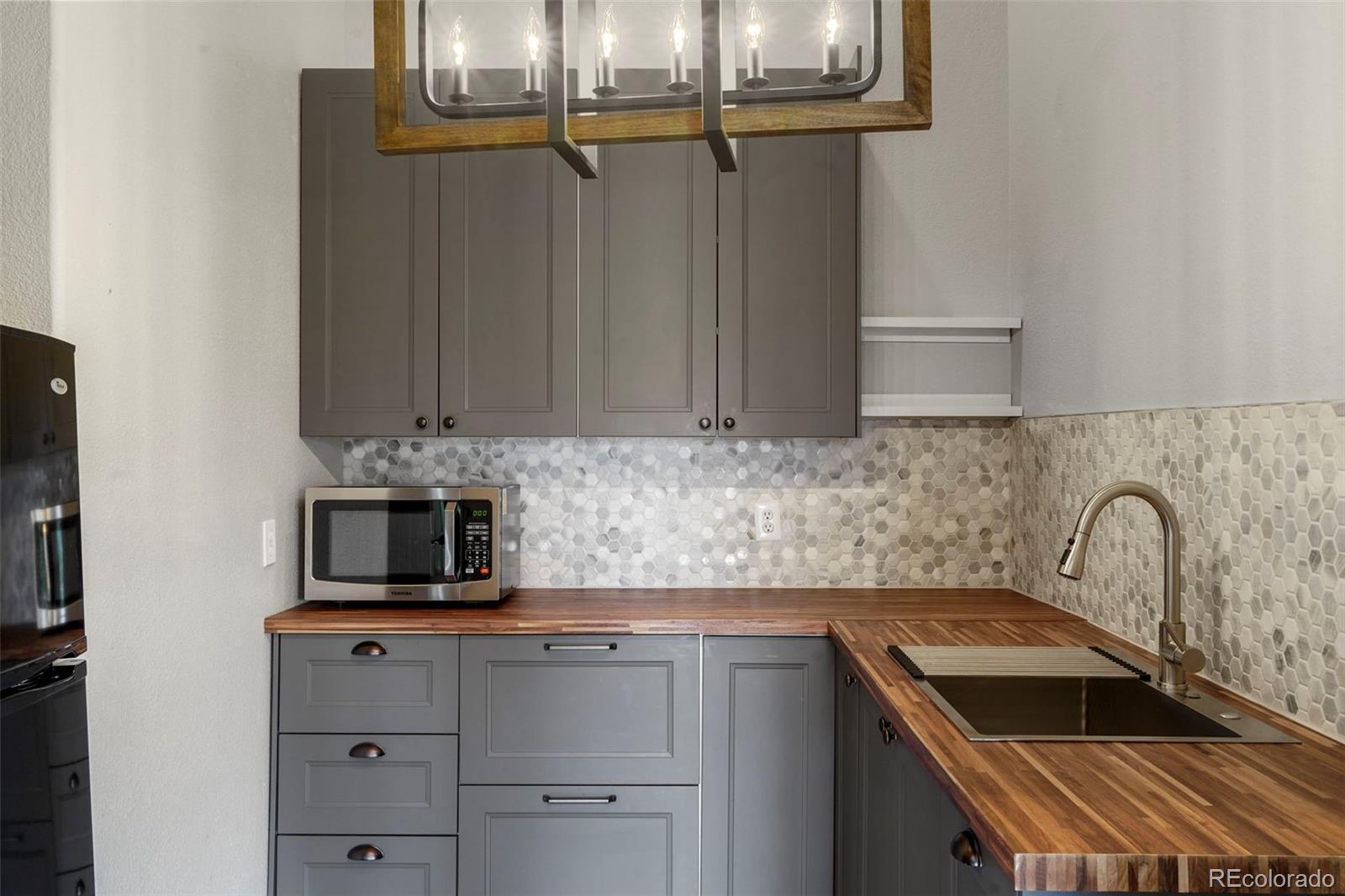 29549 Thunderbolt Circle Conifer, CO 80433 - Photo 28 of 50 a kitchen with a sink and cabinets