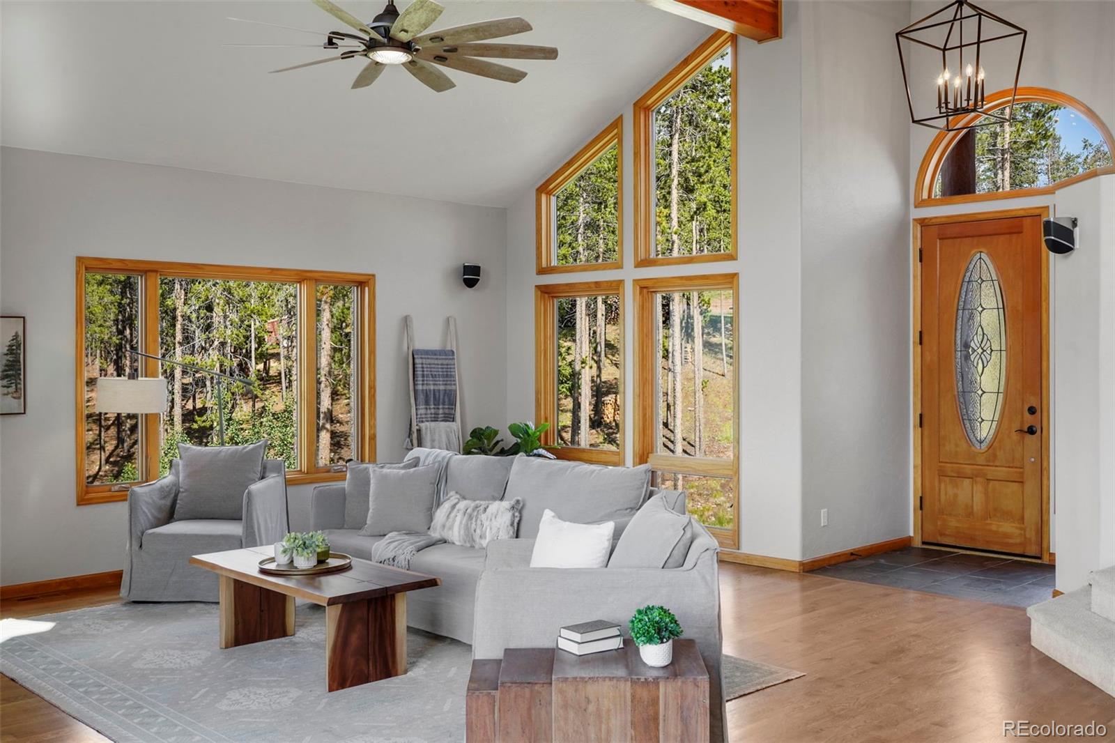 29549 Thunderbolt Circle Conifer, CO 80433 - Photo 3 of 50 a living room with furniture a table and a large window