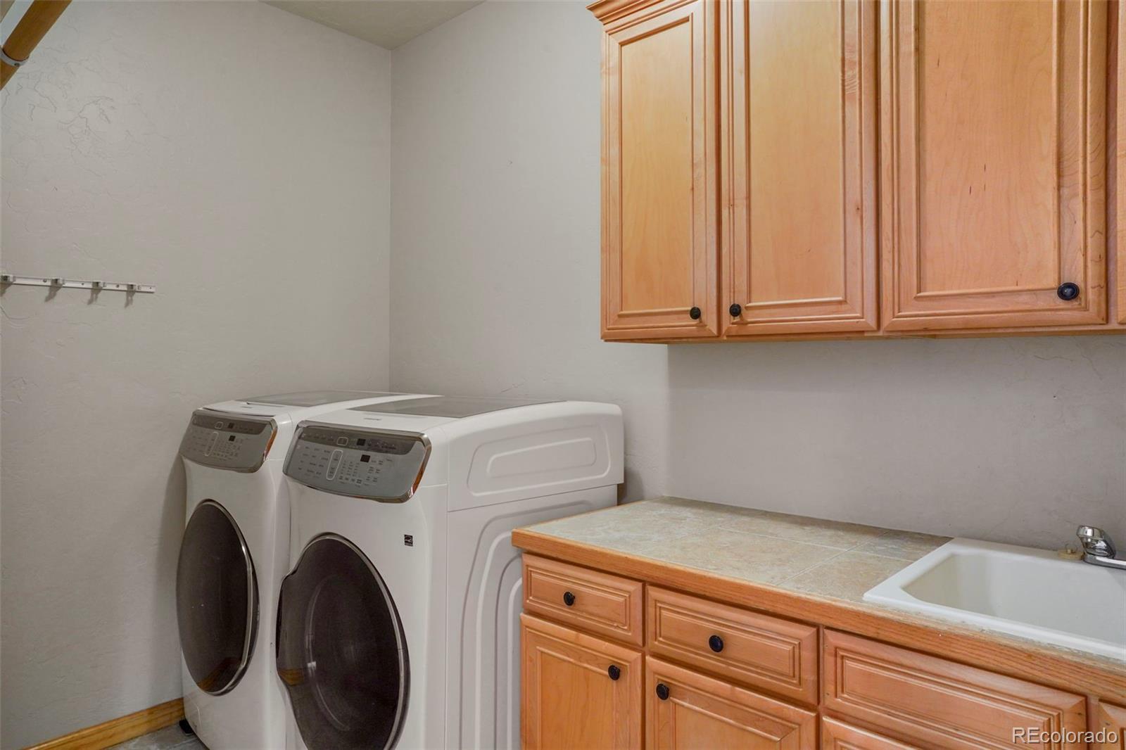 29549 Thunderbolt Circle Conifer, CO 80433 - Photo 31 of 50 a utility room with dryer and washer