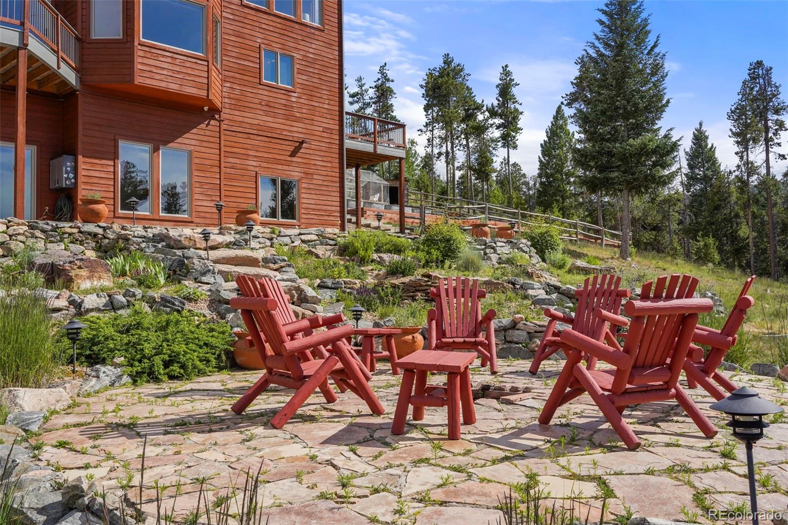 29549 Thunderbolt Circle Conifer, CO 80433 - Photo 34 of 50 a view of a chairs and table in the backyard