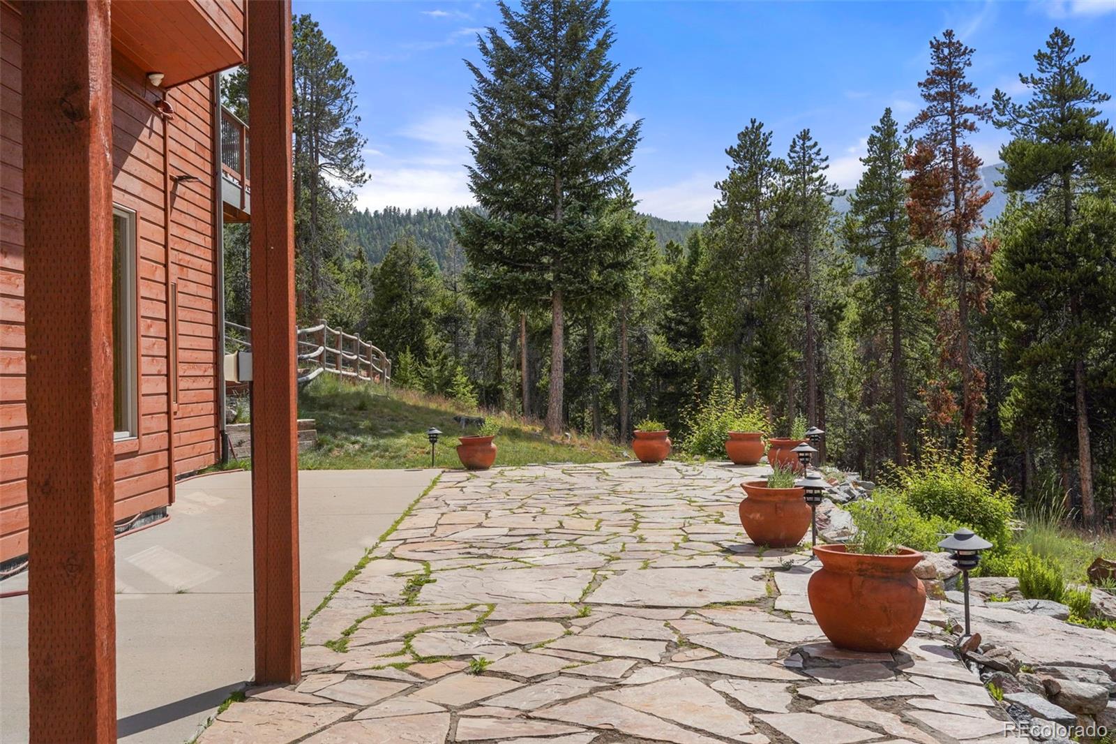 29549 Thunderbolt Circle Conifer, CO 80433 - Photo 35 of 50 a view of a backyard with sitting area
