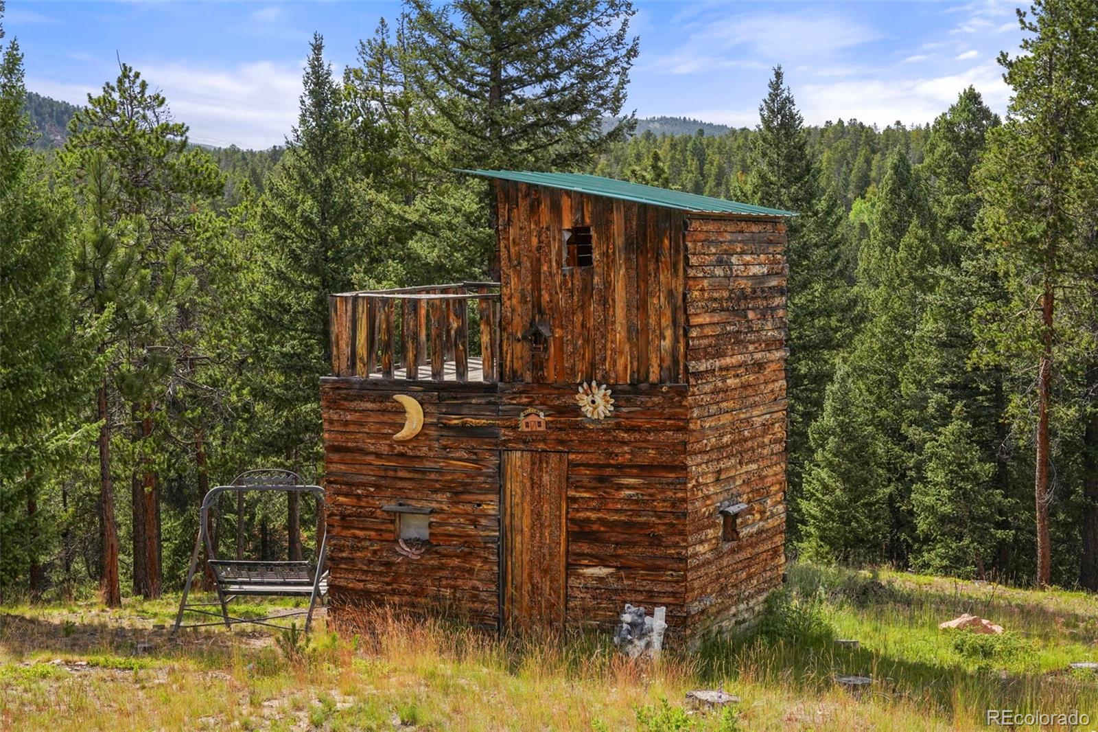 29549 Thunderbolt Circle Conifer, CO 80433 - Photo 39 of 50 a view of house with swimming pool and trees in the background
