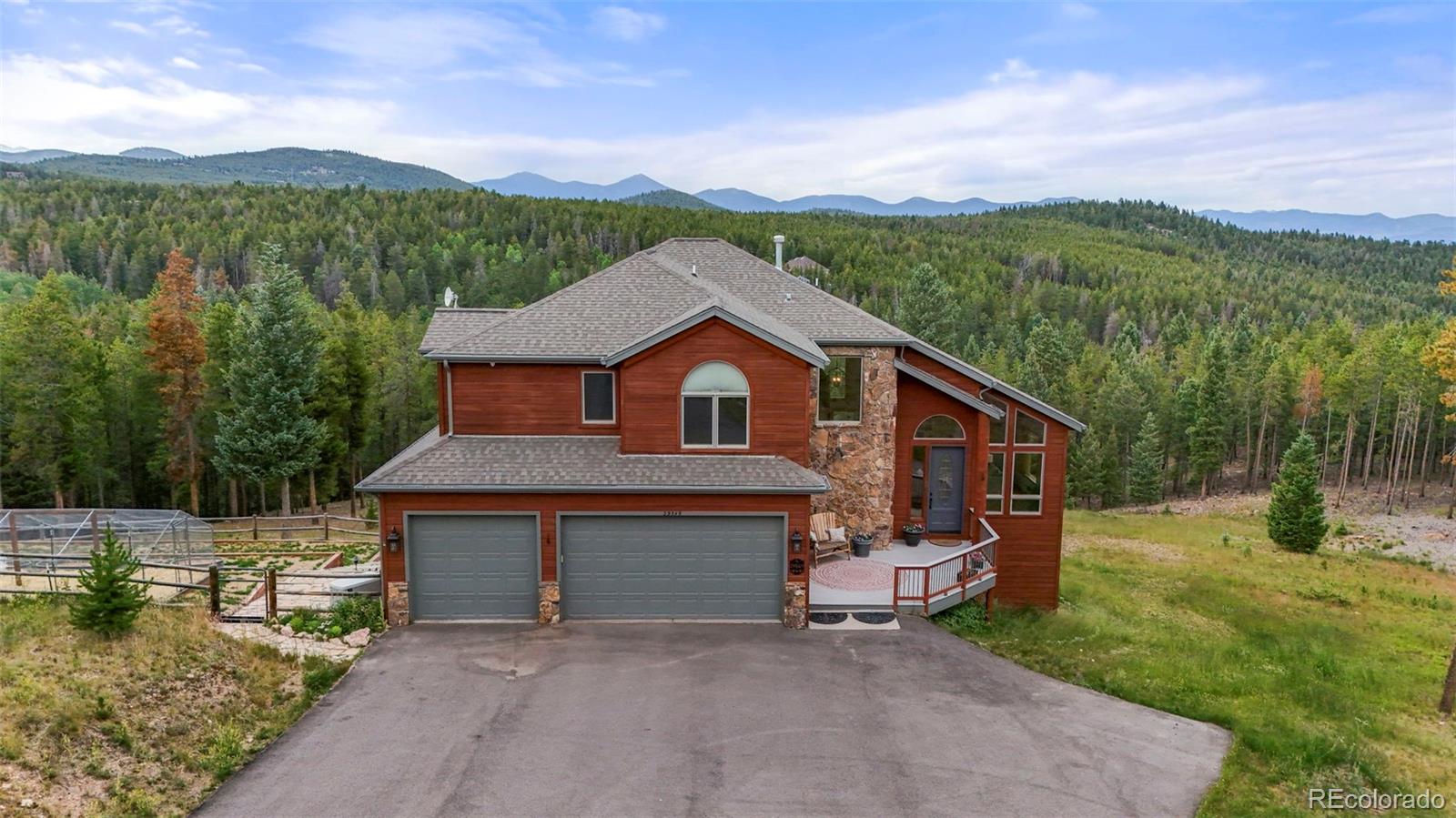 29549 Thunderbolt Circle Conifer, CO 80433 - Photo 41 of 50 a front view of a house with a yard and garage