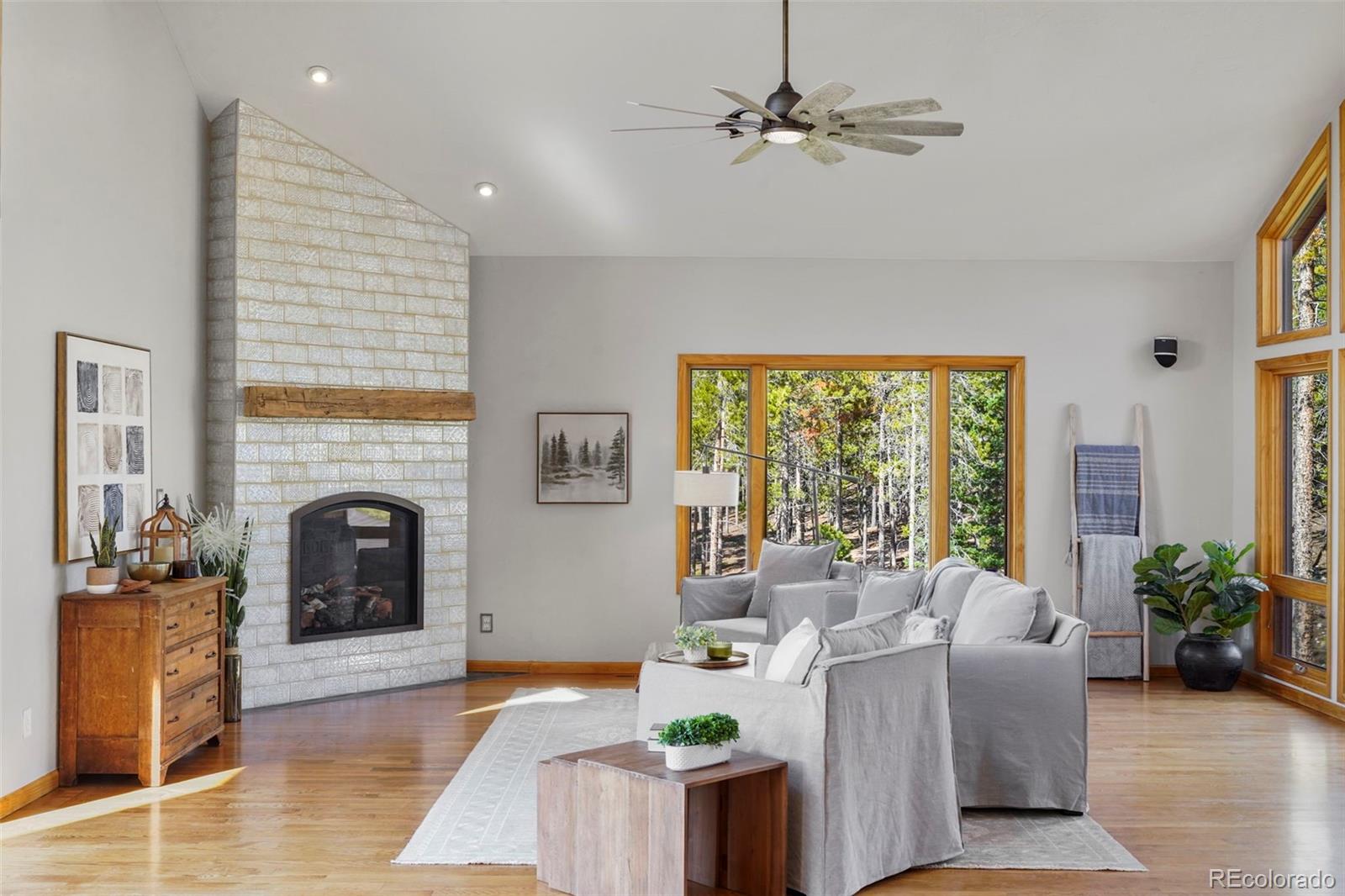 29549 Thunderbolt Circle Conifer, CO 80433 - Photo 5 of 50 a living room with furniture large window and fireplace