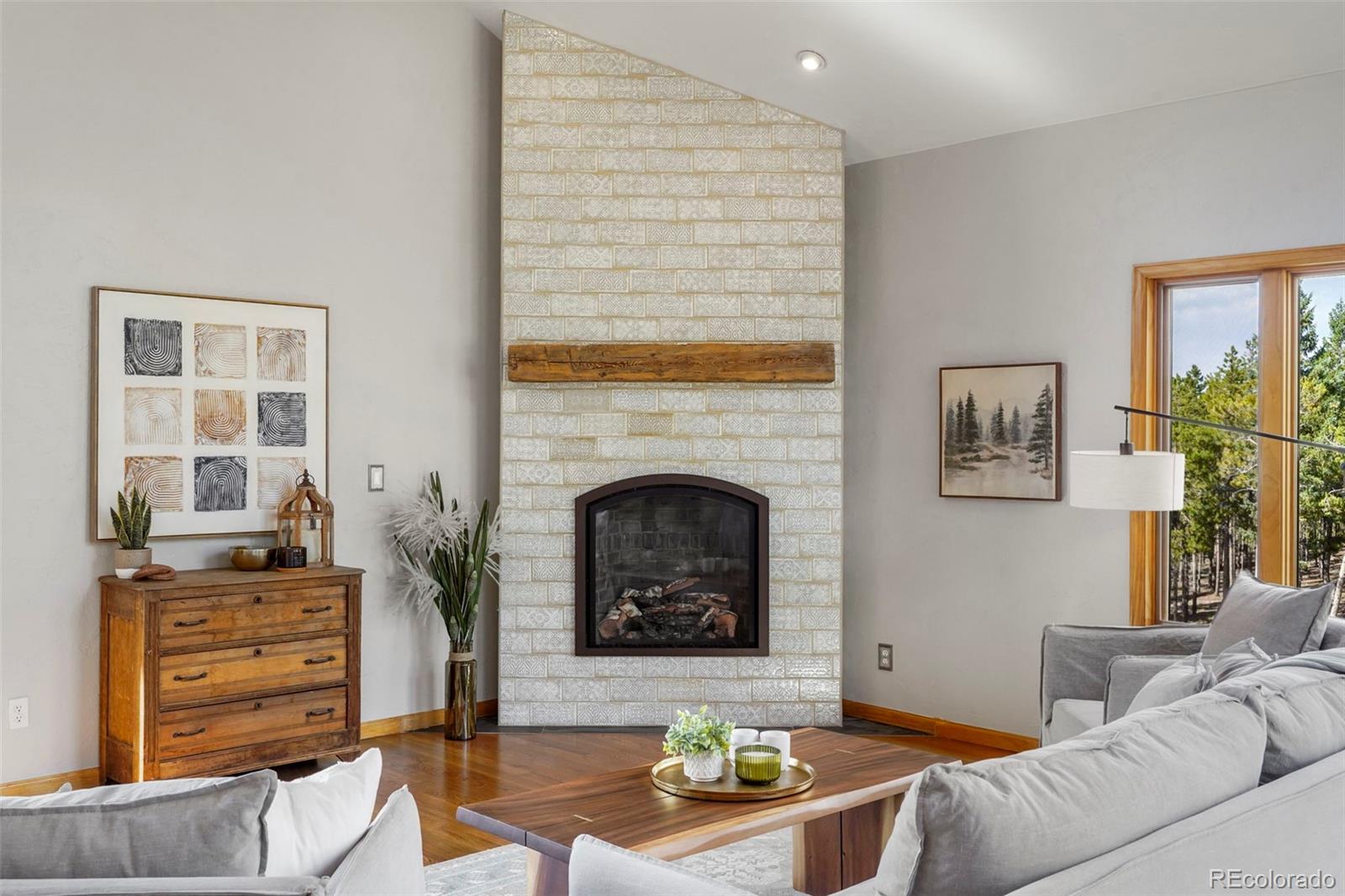 29549 Thunderbolt Circle Conifer, CO 80433 - Photo 6 of 50 a living room with furniture and a fireplace