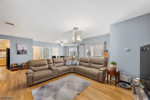a living room with furniture and a chandelier