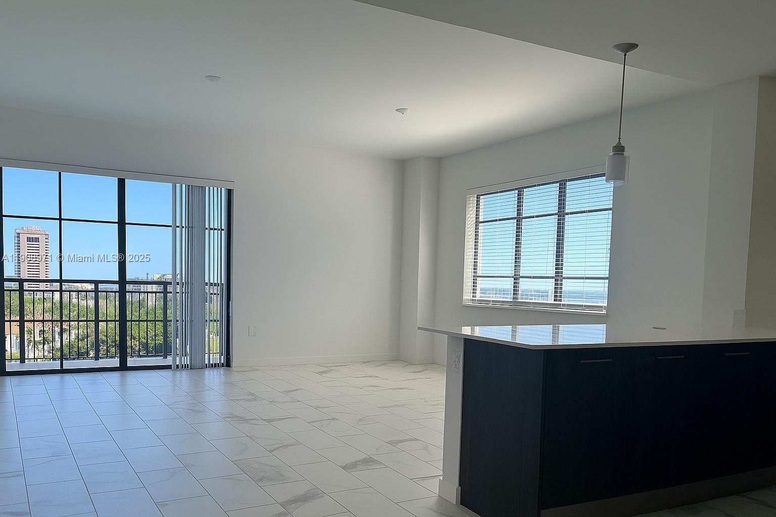 101 East Camino Real, Unit 517 Boca Raton, FL 33432 - Photo 2 of 12 an empty room with windows