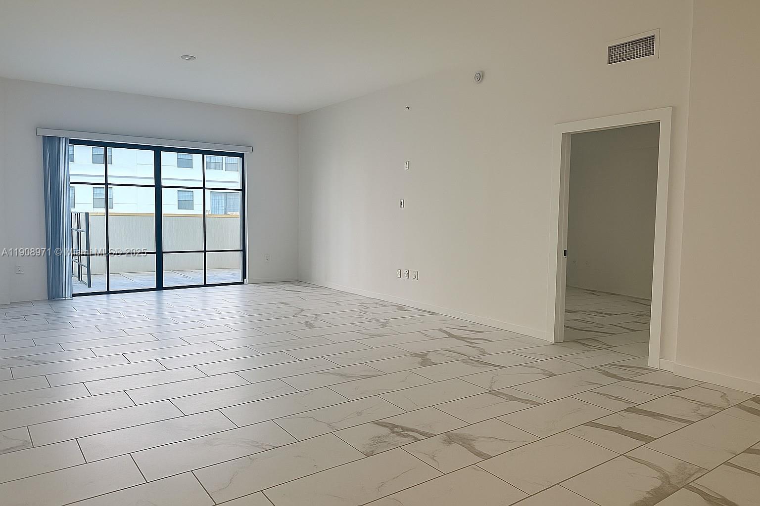 101 East Camino Real, Unit 517 Boca Raton, FL 33432 - Photo 5 of 12 an empty room with windows