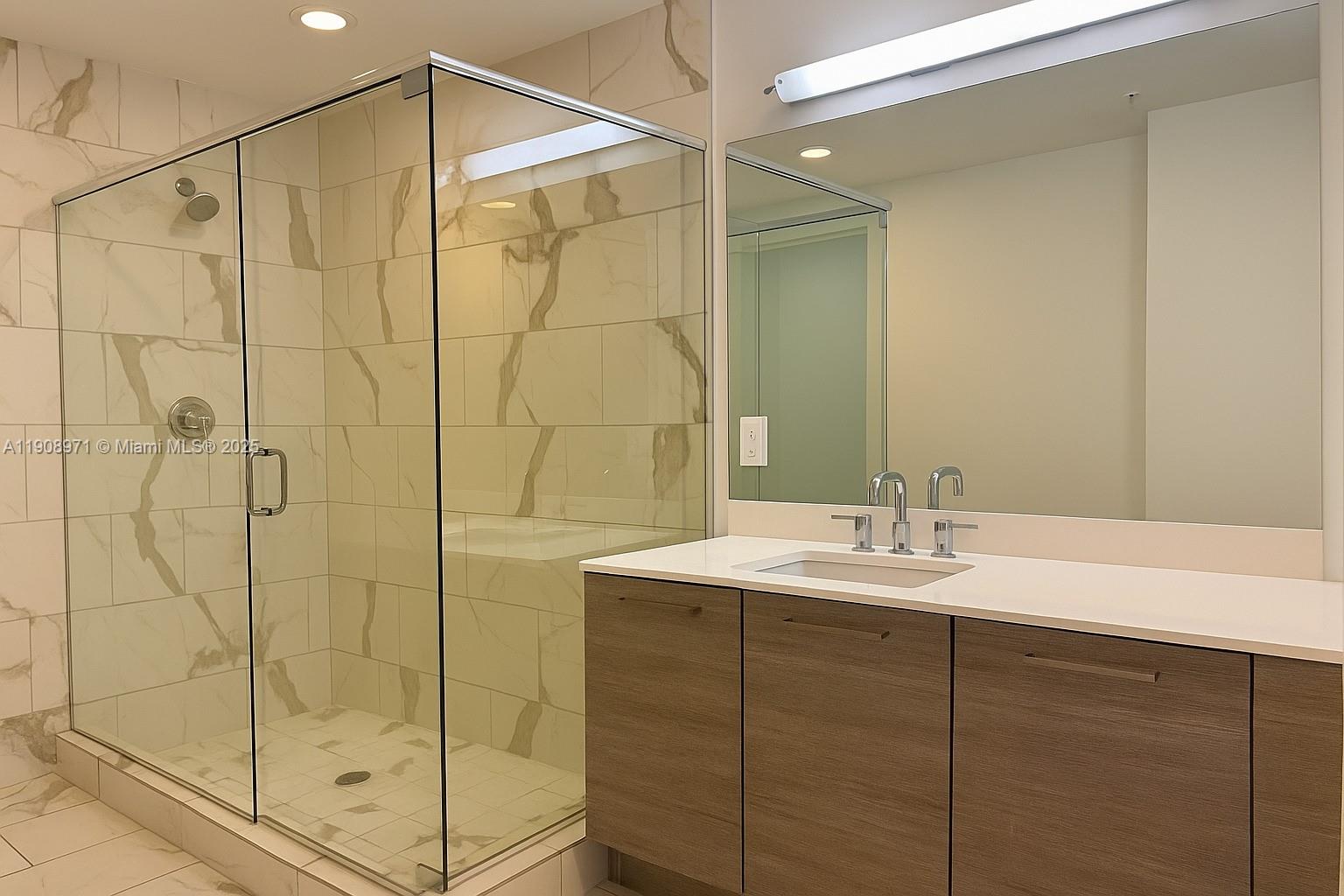 101 East Camino Real, Unit 517 Boca Raton, FL 33432 - Photo 8 of 12 a bathroom with a shower and a sink