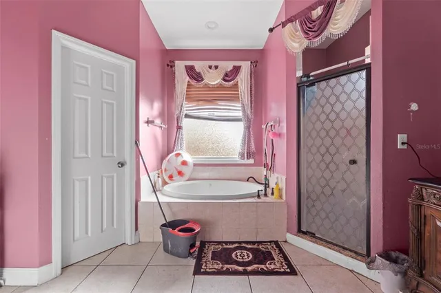 a bathroom with a bathtub and shower