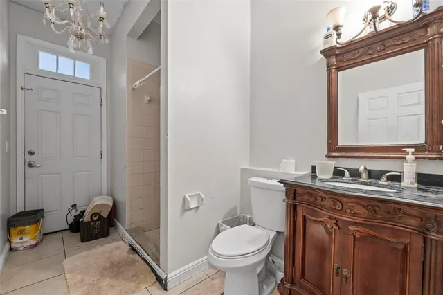 a bathroom with a toilet a sink and mirror
