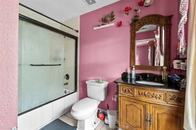 a bathroom with a toilet sink and shower