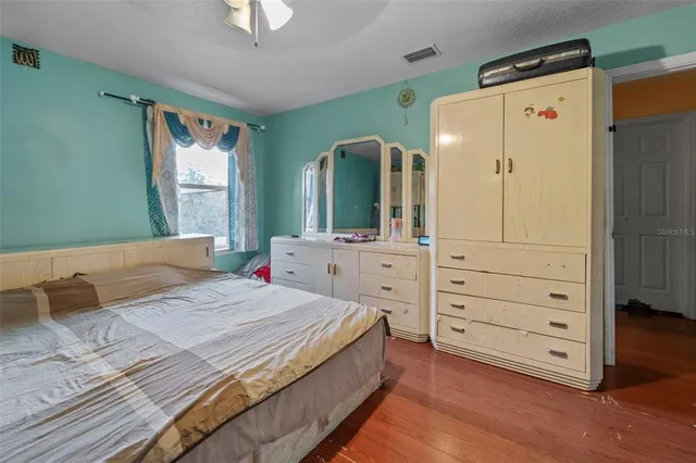 a bedroom with a bed and a dresser