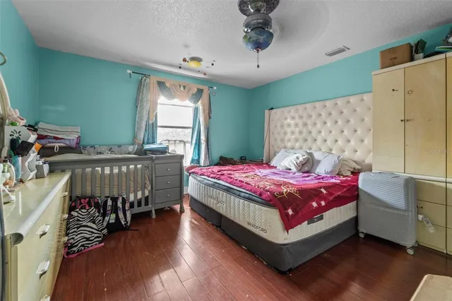 a bedroom with a bed and a chandelier