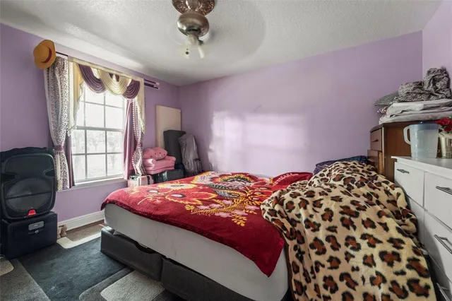 a bedroom with bed and window