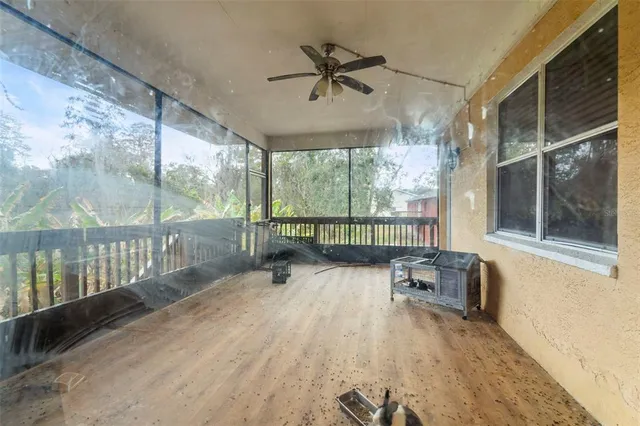 a view of a porch with furniture and a gate