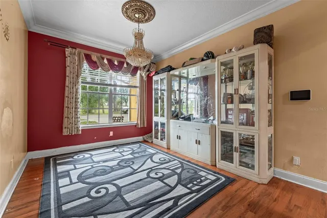 a view of a room with wooden floor and windows