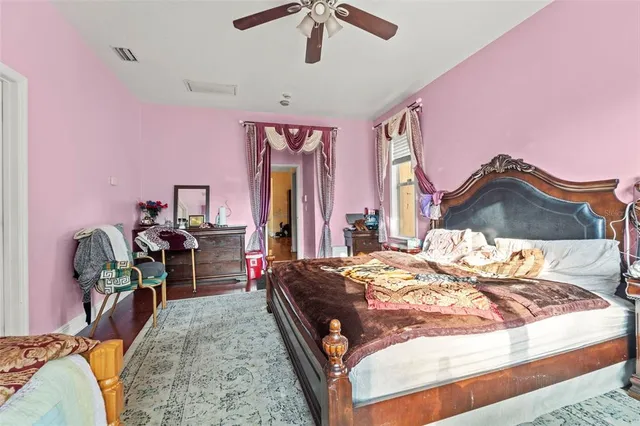 a bed room with a bed and a chair