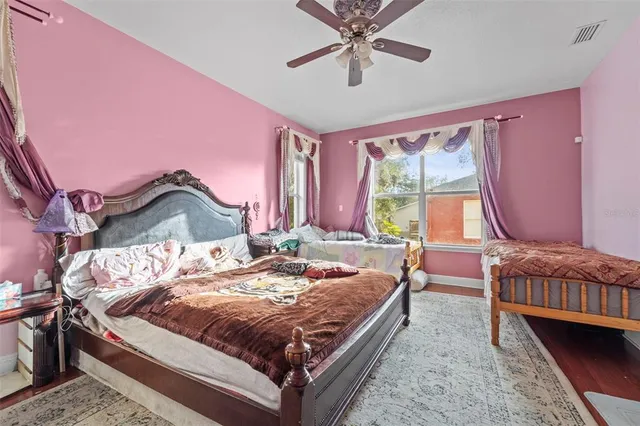 a bed sitting in a bedroom next to a window