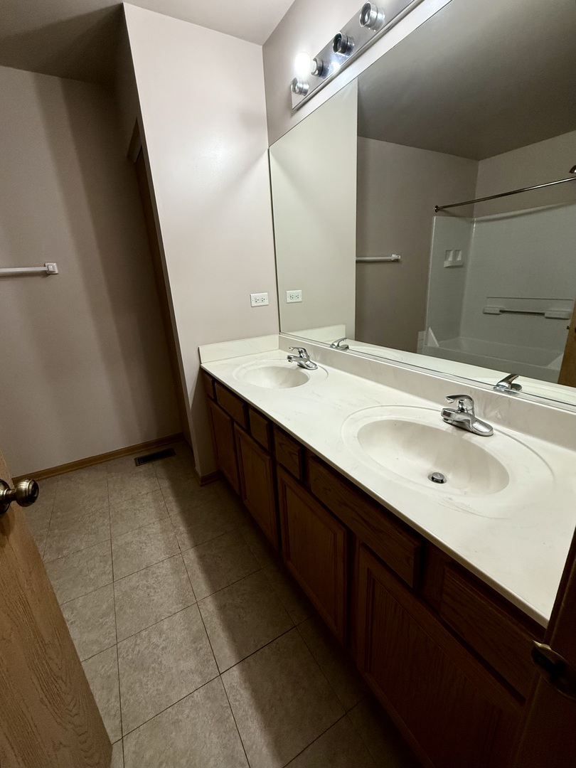 412 Clifton Lane Bolingbrook, IL 60440 - Photo 8 of 12 a bathroom with a sink and a mirror