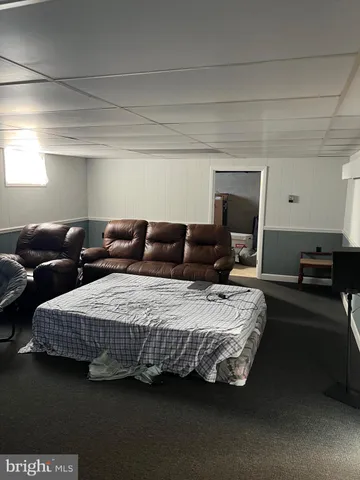 a bedroom with bed and a couch