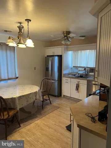 a kitchen with kitchen island a stove a refrigerator and wooden cabinets