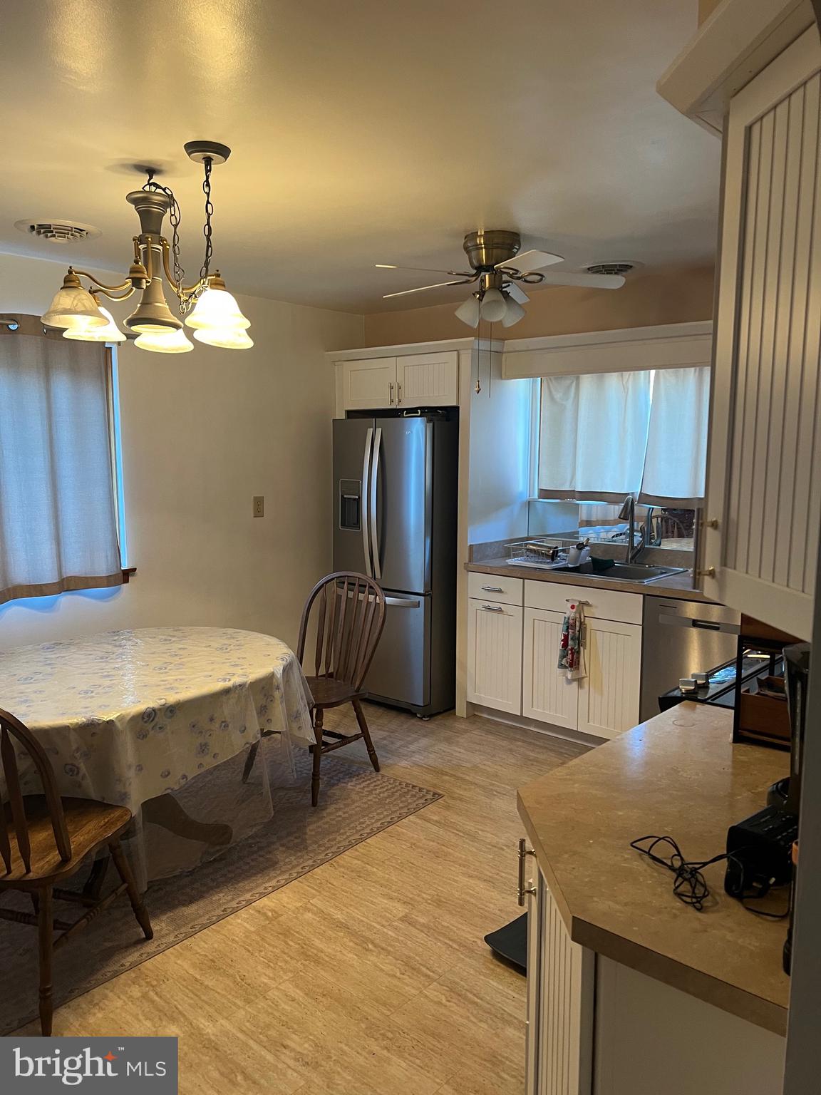 11915 Bedford Road Northeast Cumberland, MD 21502 - Photo 8 of 34 a kitchen with kitchen island a stove a refrigerator and wooden cabinets