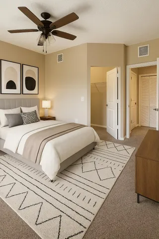 a bedroom with a large bed and a chandelier