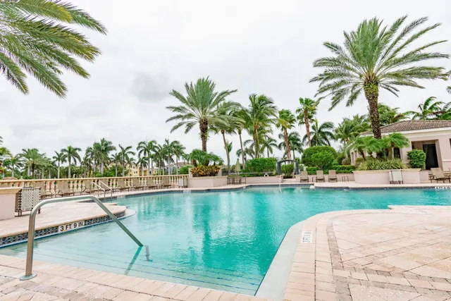 a view of a lake with a garden and swimming pool