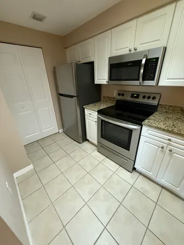 a kitchen with stainless steel appliances a stove a microwave and a refrigerator