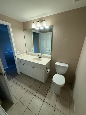 a bathroom with a sink toilet and a mirror