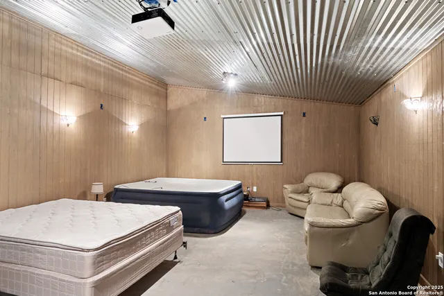 a room with a table chairs and a chandelier