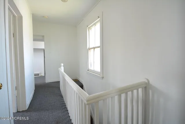 a view of a hallway with windows