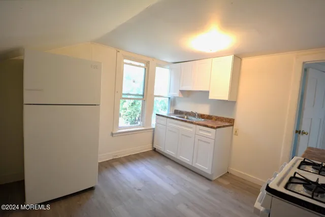 a kitchen with a refrigerator and a stove