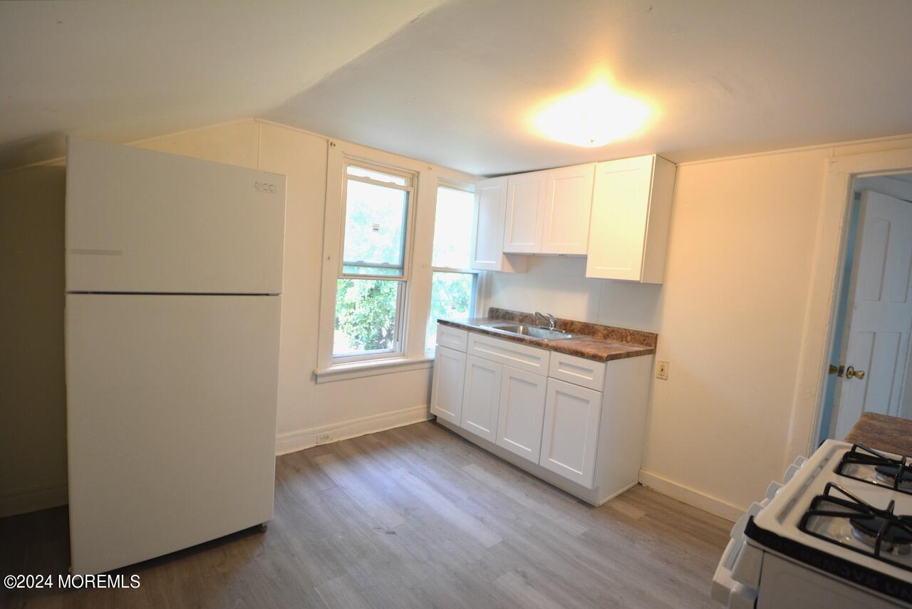193 Union Avenue, Unit 2 Long Branch, NJ 07740 - Photo 4 of 10 a kitchen with a refrigerator and a stove