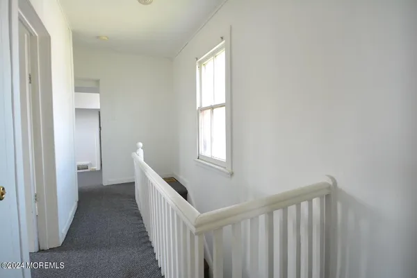 a view of a hallway with windows
