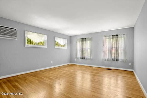 21 Hycliff Road, Unit COTTAGE Greenwich, CT 06831 - Photo 3 of 7 a view of empty room with window and wooden floor