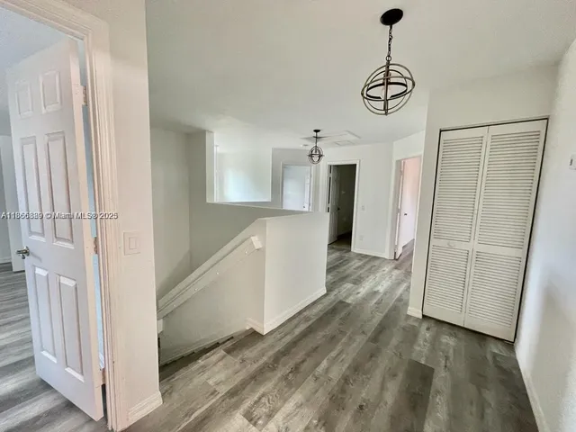 a view of a kitchen with a sink and refrigerator