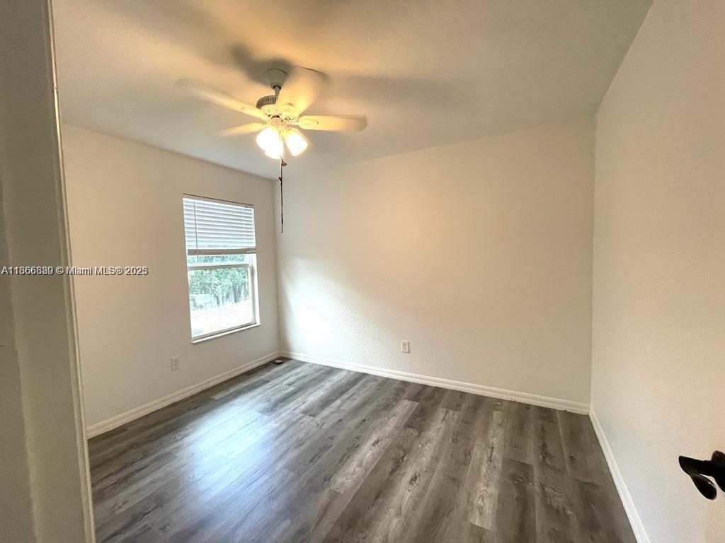 804 Quartz Terrace West Palm Beach, FL 33413 - Photo 12 of 15 wooden floor in an empty room with a window