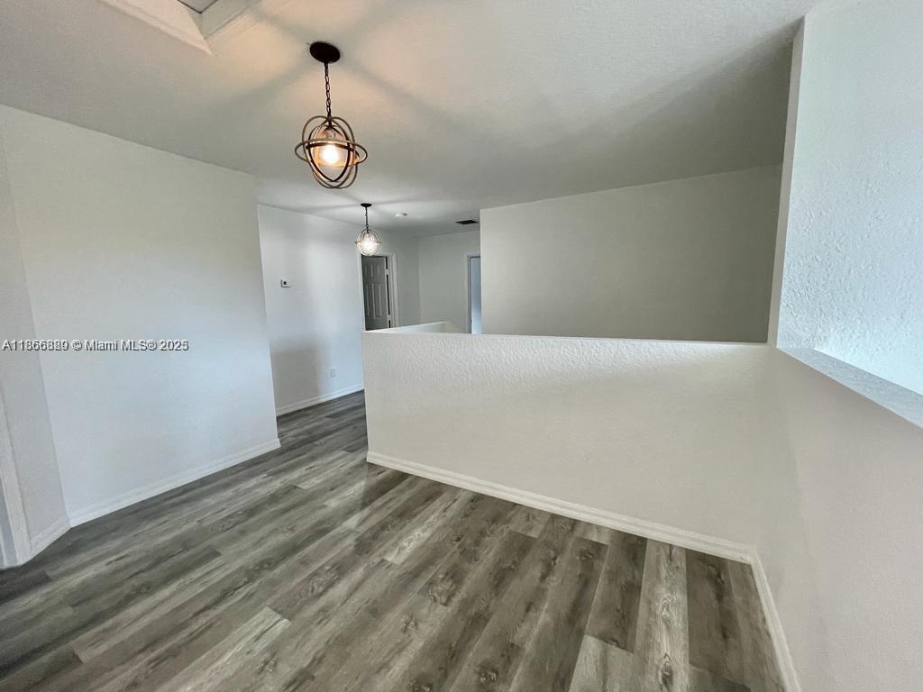 804 Quartz Terrace West Palm Beach, FL 33413 - Photo 14 of 15 a view of an empty room with wooden floor and windows