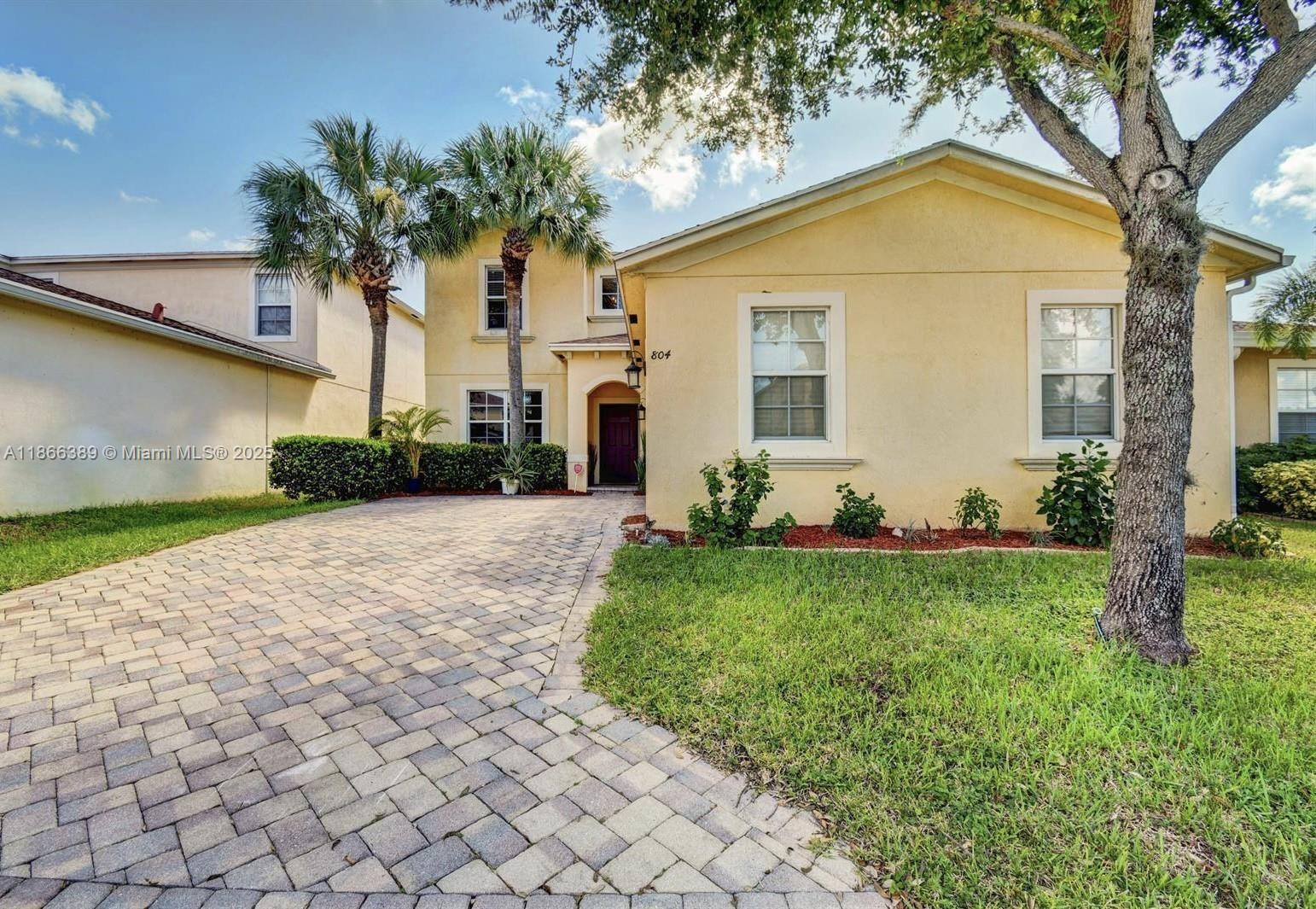 804 Quartz Terrace West Palm Beach, FL 33413 - Photo 2 of 15 a front view of a house with garden