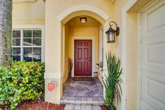 a couple of potted plants in front of a door