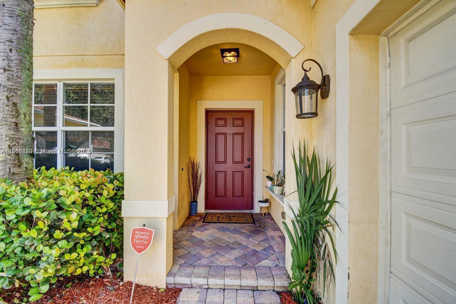 804 Quartz Terrace West Palm Beach, FL 33413 - Photo 3 of 15 a couple of potted plants in front of a door